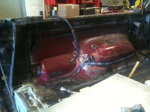 1993 Ford Bronco - The interior of a vehicle is being worked on, with visible welding and metal repairs.