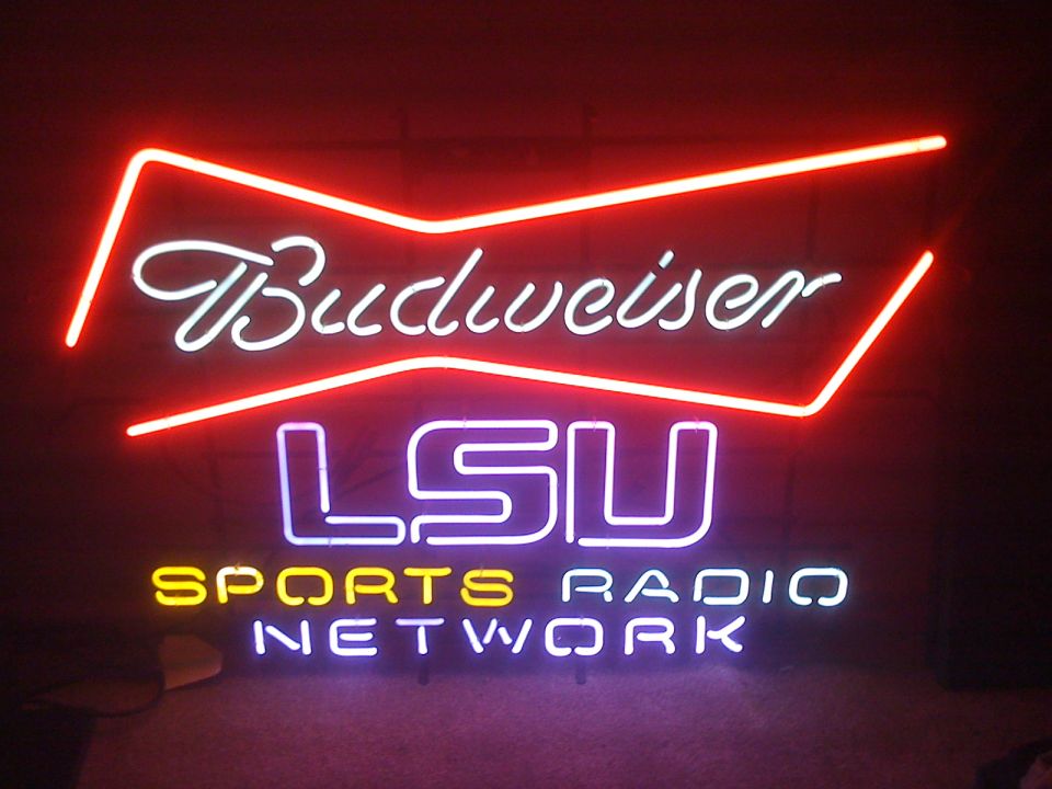 Lit Budweiser LSU Sports Radio Network neon sign in a dark room