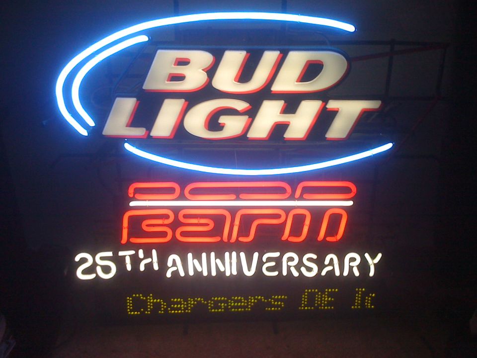Bud Light ESPN 25th Anniversary neon sign glowing in a dark room
