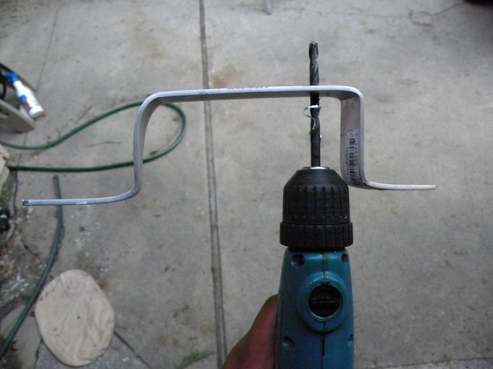 metal bracket held by drill bit