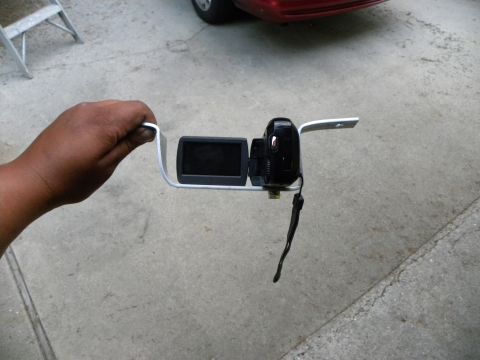 1995 Ford Bronco - Video camera mounted on a custom bracket, with a red car in the background.