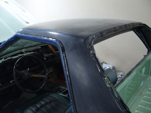 1973 Ford Ranchero - Interior view of a 1973 Ford Ranchero, showing the dashboard and primer-coated roof panel during bodywork.