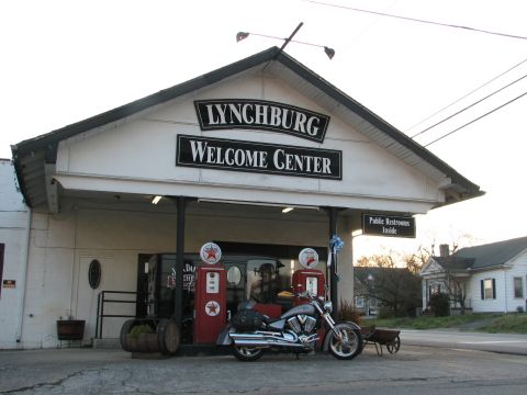 2006 Victory Kingpin - A 2006 Victory Kingpin motorcycle is parked outside the Lynchburg Welcome Center, with vintage gas pumps visible.