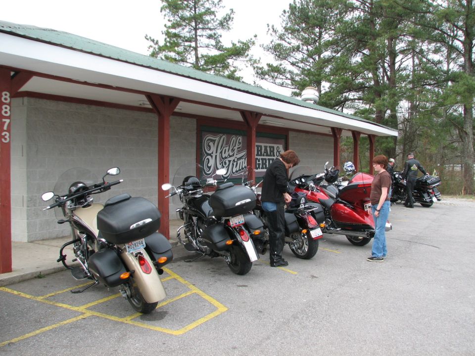 Line of touring motorcycles with top cases parked outside Half Time Bar & Grill