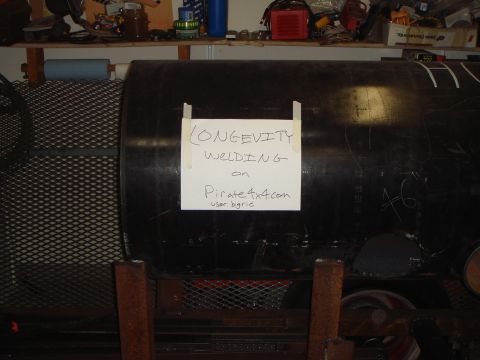 1992 Ford Bronco - A large metal tank, possibly a smoker, has a handwritten sign taped to its side.
