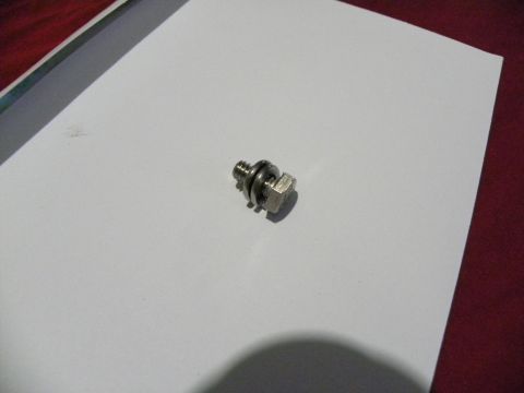 1995 Ford Bronco - A single bolt with a washer is shown on a white surface.