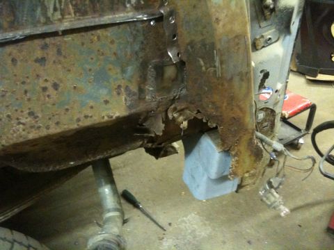 1993 Ford Bronco - The vehicle's frame shows significant rust and damage, indicating extensive repair needs.