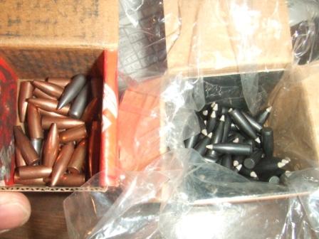 1996 Ford Bronco - Two boxes contain ammunition, one with copper bullets and the other with black bullets.