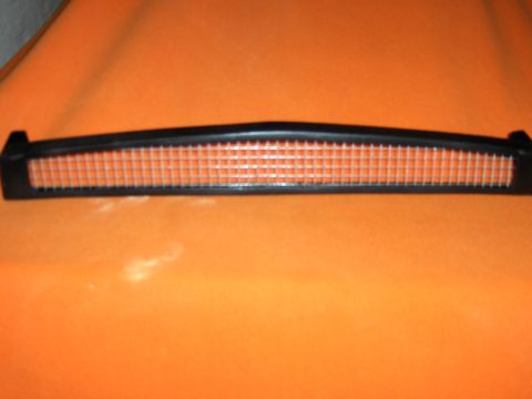 1980 Chevrolet Camaro - A close-up of a car's grille insert with a distinctive orange mesh pattern.