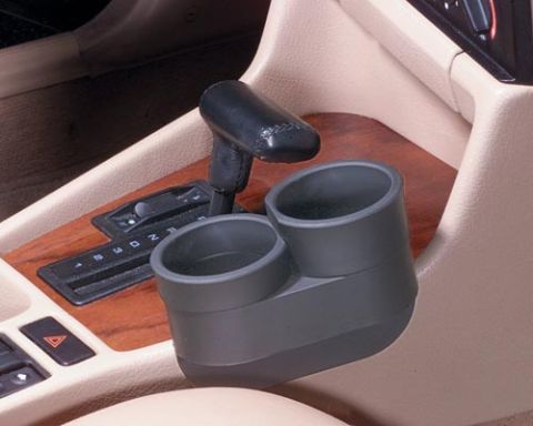 1994 BMW 5 Series - The interior of a 1994 BMW 5 Series shows the center console with a cupholder and automatic gear shifter.