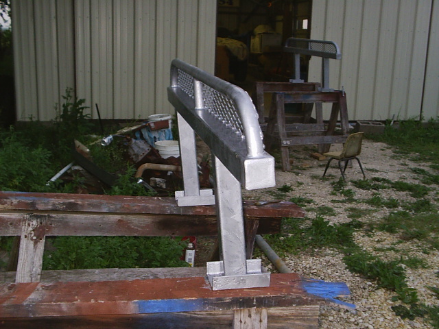 Fabricated aluminum step bar with diamond-plate top on a wooden pallet outdoors