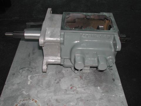 1948 Jeep Wrangler - A gray transmission part is shown on a metal surface.