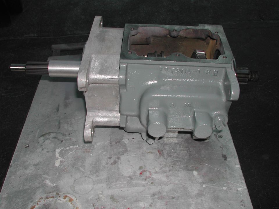 Gray transmission housing with a metal shaft extending from the left side