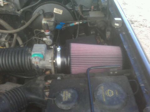1994 Ford F-150 - Close-up of a vehicle's engine bay, highlighting an aftermarket K&N air filter and intake system.