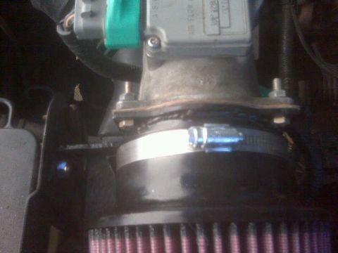 1994 Ford F-150 - Engine air intake assembly with a red filter element and metal clamp visible.