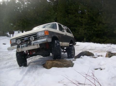 1991 Ford Bronco - This 1991 Ford Bronco navigates a snowy, rocky terrain with its front end lifted.