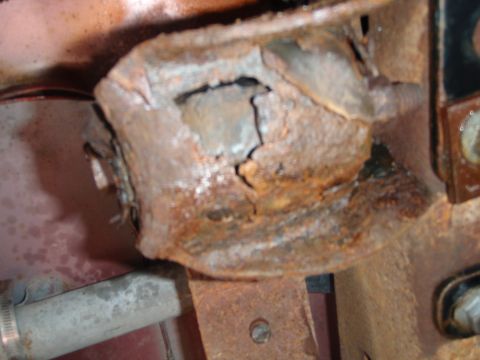 1995 Ford Bronco - Close-up of a corroded metal component, indicating significant wear and tear.