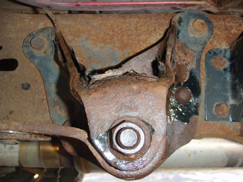 1995 Ford Bronco - Close-up of a severely corroded vehicle frame component, showing significant rust damage.