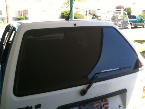 1991 Ford Festiva - Rear view of a white 1991 Ford Festiva with tinted windows and an Arizona license plate.