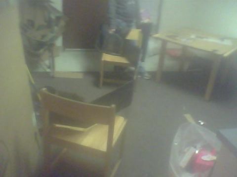2000 Dodge 1500 - A room interior with furniture, including a chair and a table. A watermark is visible in the lower right corner.