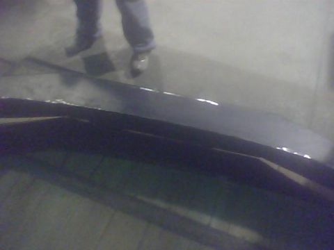 2000 Dodge 1500 - A person stands over the bed of a dark-colored truck, with reflections on the surface.