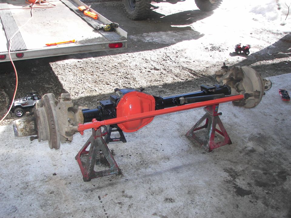 Front axle assembly on jack stands, red differential cover