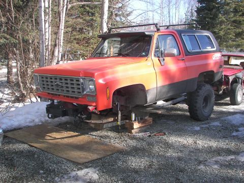 1990 Chevrolet Suburban - This 1975 Chevrolet K5 Blazer is being worked on, with its front end elevated on wooden blocks.