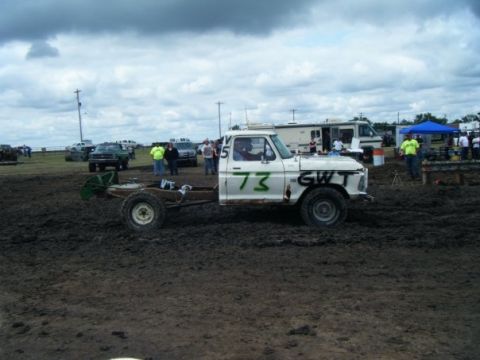 2000 Dodge 1500 - A white pickup truck chassis with a cab sits in the mud, marked with the number 73 and 'GWT'.