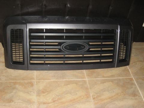 2008 Ford F-250 - Ford Super Duty grille with horizontal bars and oval Ford emblem visible.