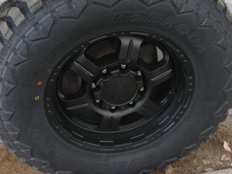 2008 Ford F-250 - Close-up of a black aftermarket wheel and tire assembly, Hankook Dynapro tires and a multi-spoke rim.