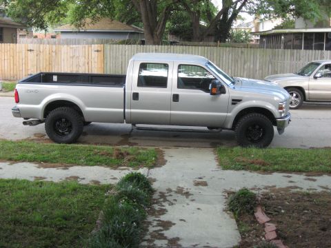 2008 Ford F-250 - Silver 2008 Ford F-250 crew cab pickup truck seen from the side.