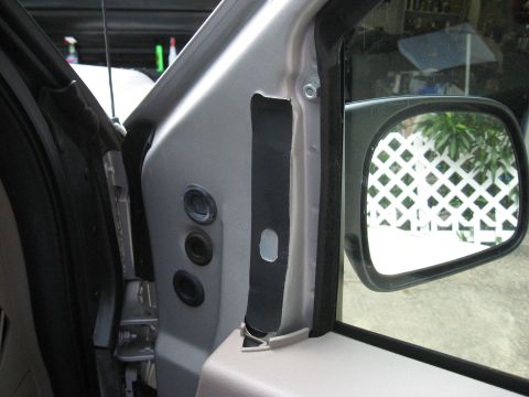 2008 Ford F-250 - The interior of a vehicle's door frame is shown, including the side mirror and some exposed wiring or trim.