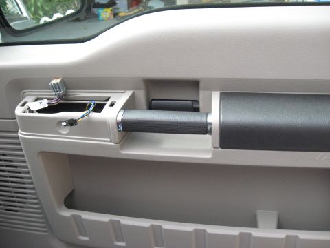 2008 Ford F-250 - Interior view of a 2008 Ford F-250 door panel, showing exposed wiring near the handle assembly.