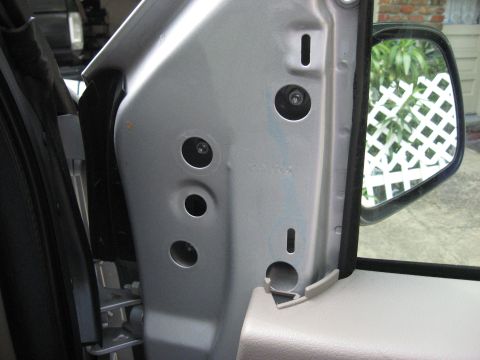 2008 Ford F-250 - The interior of a vehicle door jamb is shown, with mounting points for a mirror and door panel visible.