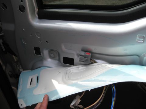 2008 Ford F-250 - Close-up of the interior door panel of a vehicle, revealing wiring and insulation components.