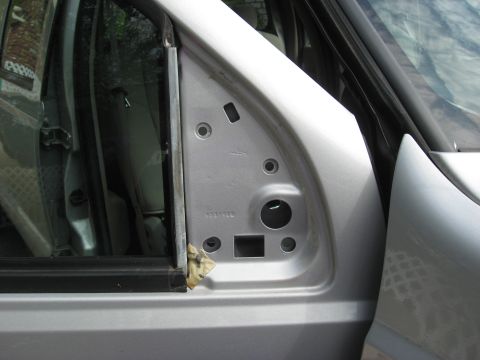 2008 Ford F-250 - Close-up of a vehicle's door frame, showing the mounting area for a side mirror and a visible part number.