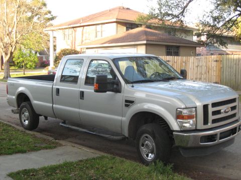 2008 Ford F-250 - This silver 2008 Ford F-250 pickup truck is parked on a residential street.
