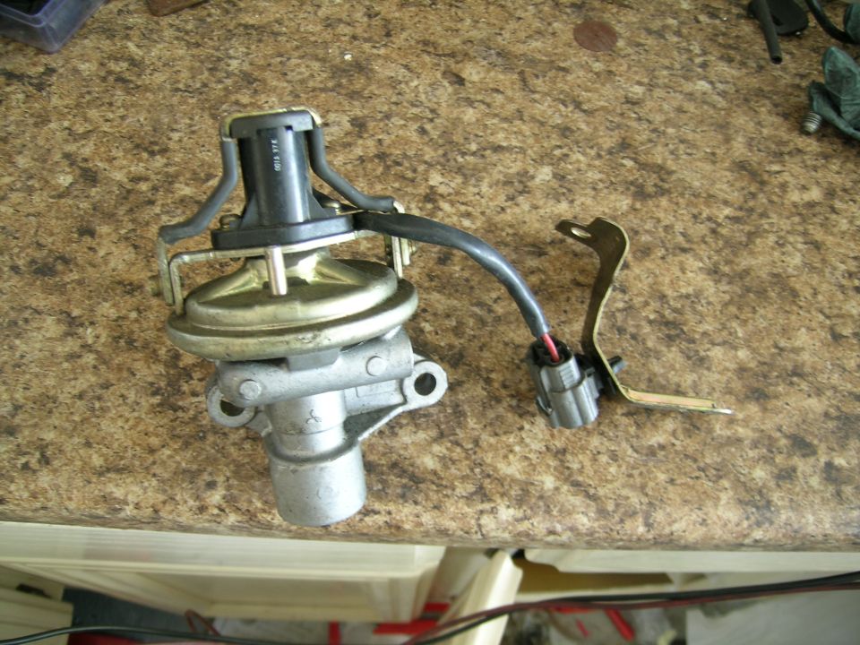 Vacuum actuator with metal bracket and electrical connector on a speckled countertop