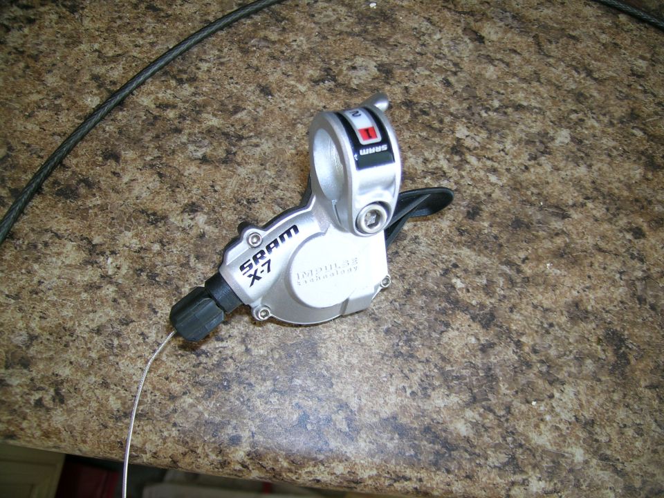 SRAM X-7 shifter with cable on speckled surface