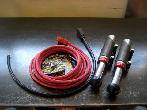 1996 Ford Bronco - Taylor Cable ignition wire set and spark plug ends are laid out on a dark surface.