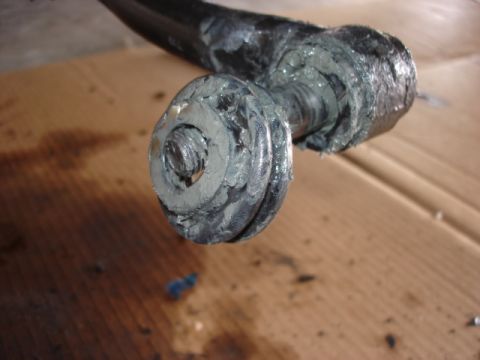 1992 Ford Bronco - Greasy suspension part with visible bolt and washer, likely needing maintenance.