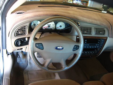 2003 Ford Taurus - The interior of a 2003 Ford Taurus is visible, including the dashboard, steering wheel, and center console.