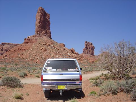 1996 Ford F-250 - Rear view of a 1996 Ford F-250 pickup truck with a camper shell in a desert landscape.