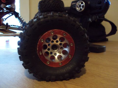 1992 Ford Ranger - Detail of a remote control car wheel and part of its controller, with 'SUPERMOTORS' visible at the bottom right.