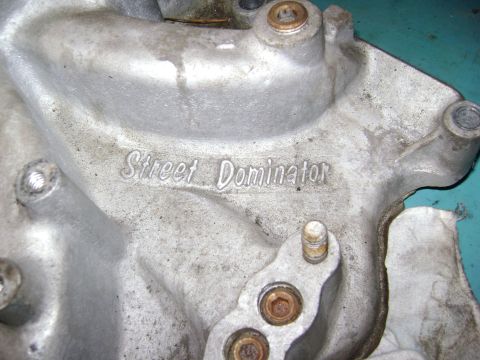 1981 Ford Mustang - Close-up of an aluminum intake manifold part showing the embossed text 'Street Dominator'.