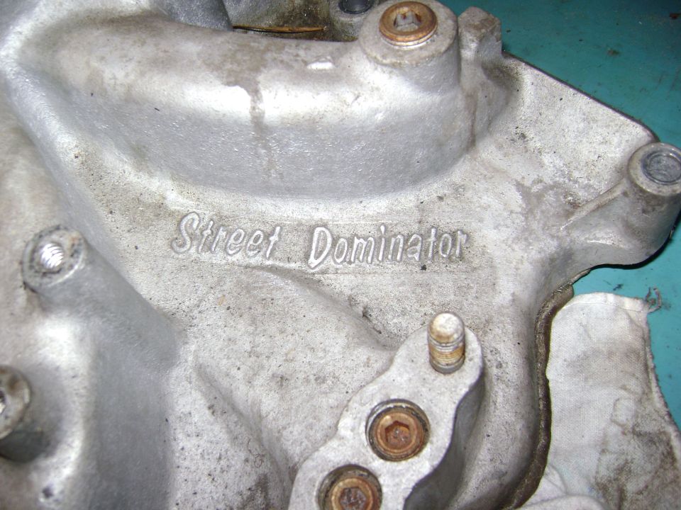 Aluminum intake manifold part with 'Street Dominator' text