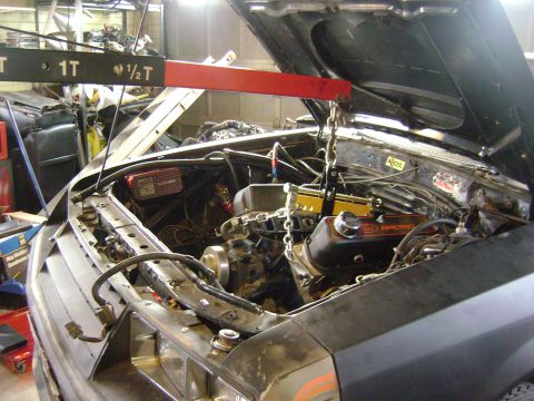 1981 Ford Mustang - Engine removal in progress for a 1981 Ford Mustang, utilizing an engine hoist.