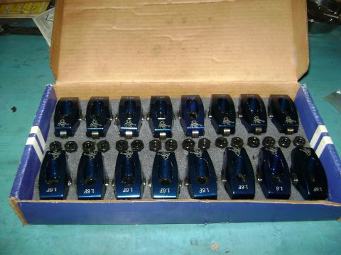 1981 Ford Mustang - A box containing sixteen blue roller rocker arms, each marked with '1.6F' and a logo.