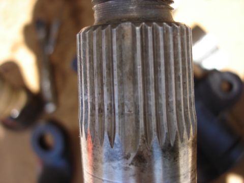1992 Ford Bronco - A close-up shot focuses on the splined end of a metal shaft, with tools blurred in the background.