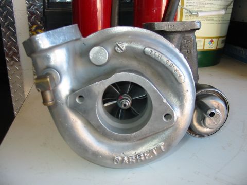 1993 Ford Taurus - A Garrett turbocharger is shown, with visible part numbers and a website logo.
